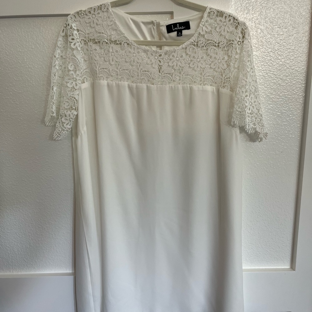Lulu’s white crepe dress with lace sleeves.